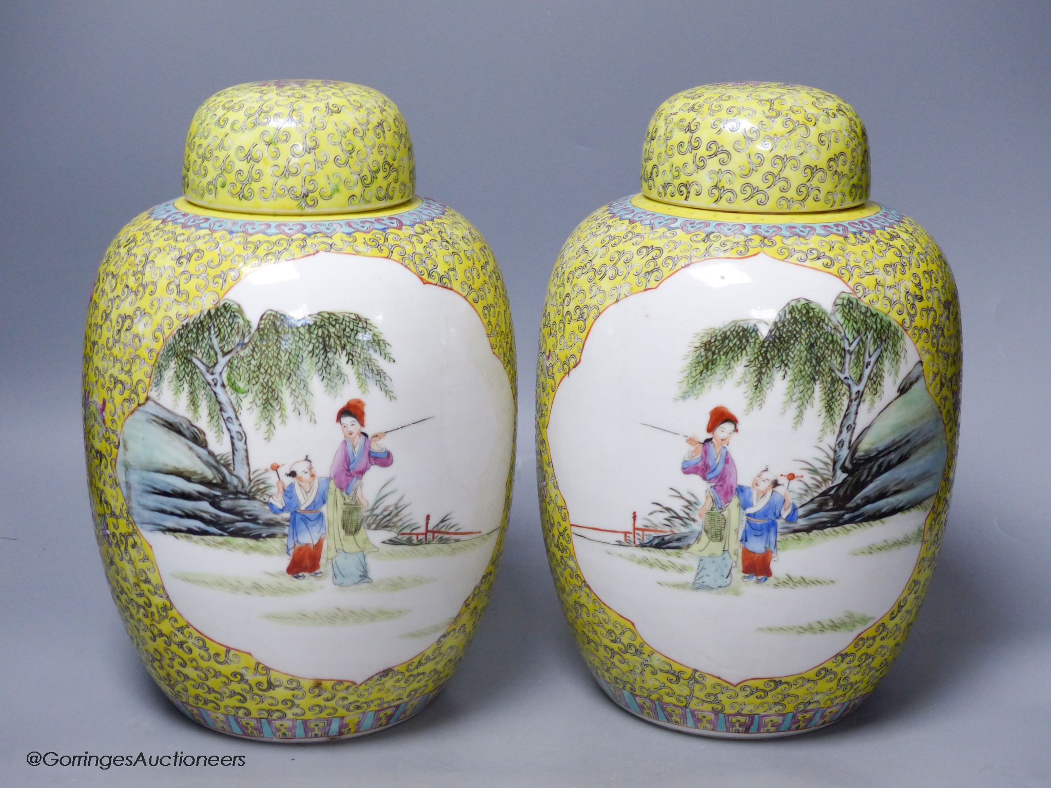 A pair of Chinese yellow ground vases and covers, height 30cm
